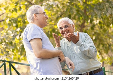 Two Happy Senior Male Friends Spending Leisure Time At Park