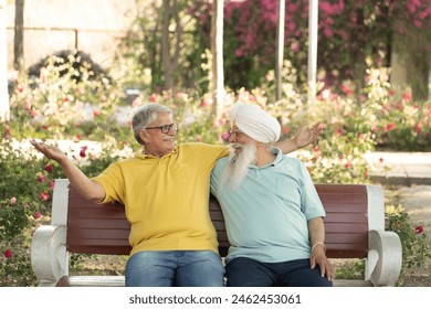 Two happy senior male friends spending leisure time at park. 
Sikh and non sikh friends fun at autumn park - Powered by Shutterstock