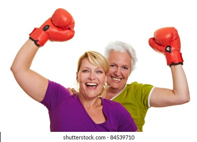 Two Happy Senior Women Cheering With Red Boxing Gloves