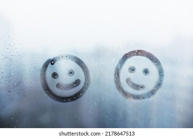 Two happy smile doodle face painted blue window flooded and raindrops