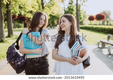 Similar – Image, Stock Photo two student girls sitting on the stairs watching the mobile