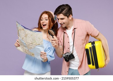 Two Happy Smiling Traveler Tourist Woman Man Couple In Shirt Hold Suitcase Paper Map Search Route Isolated On Purple Background Passenger Travel Abroad On Weekends Getaway Air Flight Journey Concept