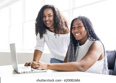 Two Happy Teen Taking A Break At Desk In Her Office