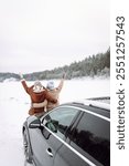 Two Happy woman near a car on a snowy road. A walk through the winter forest. Winter holidays. Journey for car.