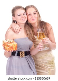two happy woman in santa hat holding glass of champagne
