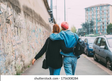 Two Happy Women Friends Walking Hugging Back View - Grateful Young Women Embracing Walking Away