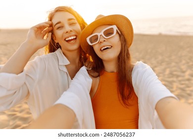 Two happy women making selfie on the coast of tropical sea. Friends together. Travel, blogging, weekend, relax and lifestyle concept. - Powered by Shutterstock