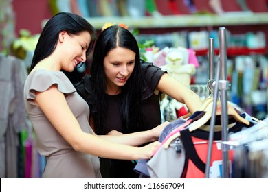 Two Happy Women Shopping In Clothes Store