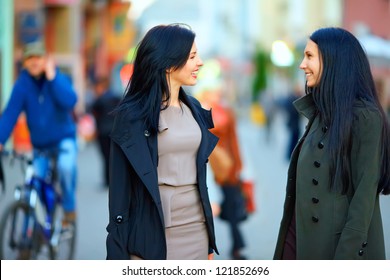 Two Happy Women Talking On Crowded City Street