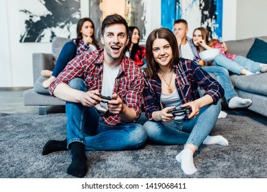 Two happy  young friends holding joystick and playing videogame. Happy time.. - Shutterstock ID 1419068411