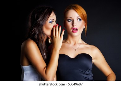 Two Happy Young Girlfriends Talking Over Black