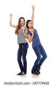 Two Happy Young Girls Friends Dancing Of Joy In Full Length, Isolated On White Background