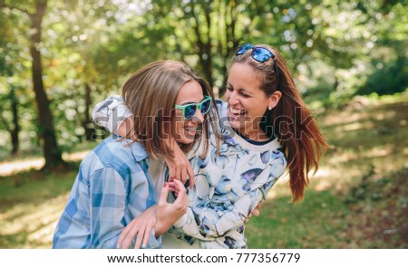 Similar – Happy women embracing and laughing over nature background