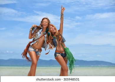 two happy young women on the beach