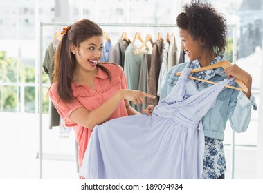 Two Happy Young Women Shopping In Clothes Store