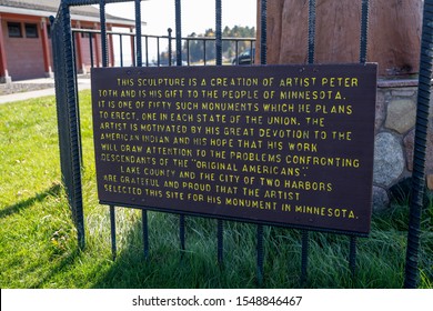 Two Harbors, Minnesota - October 20, 2019: Informational Plaque For The Totem Pole Of The Trail Of The Whispering Giants By Artist Peter Wolf Toth