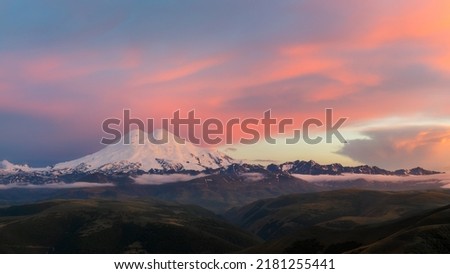 Two headed mount Elbrus and the Main Caucasian Range under the sunset light. Elbrus is the highest mountain in the Europe, stratovolcano. 