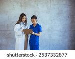 Two healthcare professionals collaborate in a modern hospital setting, smiling while discussing patient information. The image portrays teamwork, professionalism, and a positive medical environment.