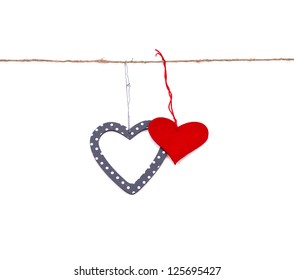 two hearts hung up on the string isolated over white