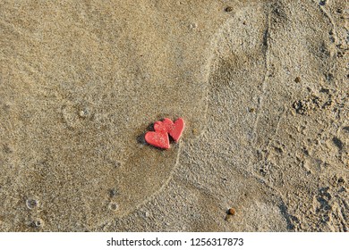 two hearts sea sand and wave love sighn valentines day concept up flat lay