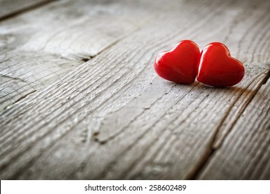 Two hearts on a wooden background concept for love, dating and romance with copyspace