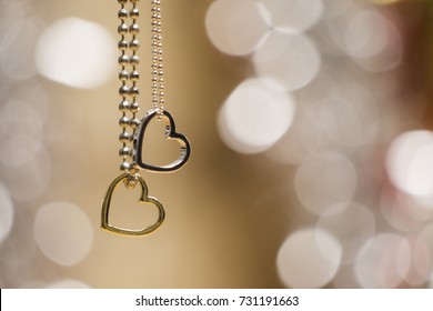 two hearts pendant necklace in blurred glowing background - Powered by Shutterstock