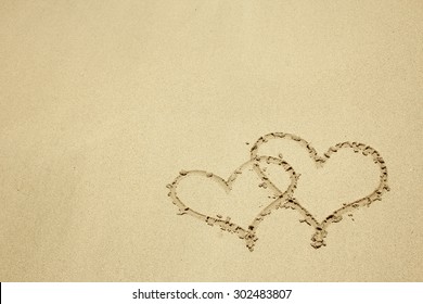 A Two Hearts In The Sand On The Beach