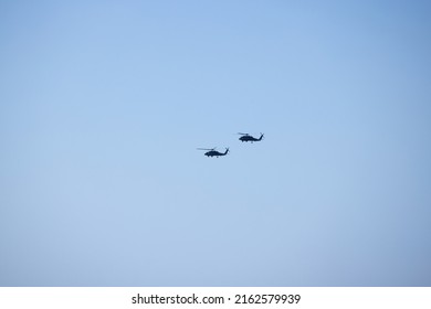 Two Helicopters Flying In The Sky