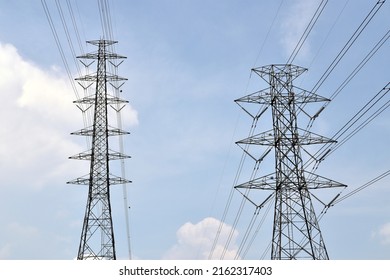 Two High Voltage Tower Pole With Electricity Transmission Power Lines And Aircraft Warning Ball And Cloudy Blue Sky, Infrastructure Domestic Electric Energy Industry