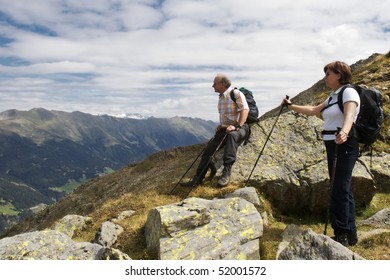 Two hiker resting near mountain summit of Lepples Kofel and being amazed about stunning view of the Alps mountain range and beautiful Defereggen valley in summer, Tyrol, Austria. - Powered by Shutterstock