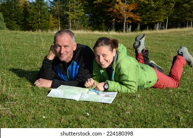 Two hikers looking at map