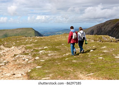 Two Hikers Walking On Snowdonia, Wales, UK