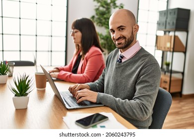 Two hispanic business workers smiling happy working at the office. - Shutterstock ID 2060243795