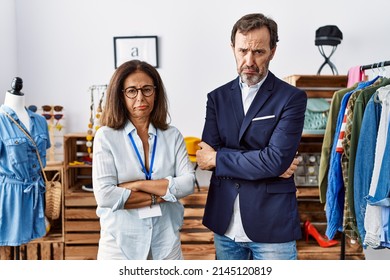 Two Hispanic People Working As Manager At Retail Boutique Depressed And Worry For Distress, Crying Angry And Afraid. Sad Expression. 