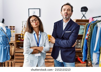 Two Hispanic People Working As Manager At Retail Boutique Looking At The Camera Blowing A Kiss Being Lovely And Sexy. Love Expression. 