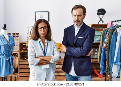 Two Hispanic People Working As Manager At Retail Boutique Skeptic And Nervous, Frowning Upset Because Of Problem. Negative Person. 