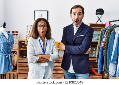 Two Hispanic People Working As Manager At Retail Boutique Afraid And Shocked With Surprise And Amazed Expression, Fear And Excited Face. 