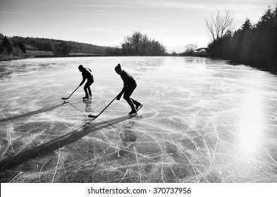 Two Hockey Players During Ice Hockey Game On Natural Ice