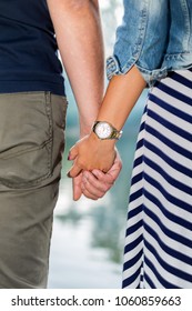 the two are holding hands