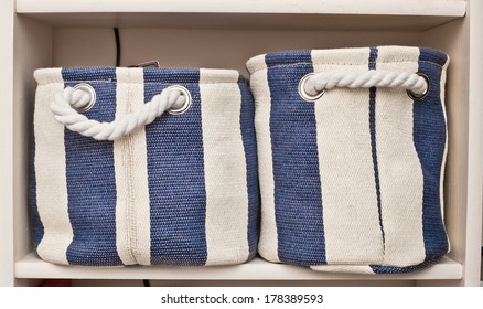 Two Home Storage Baskets On A Shelving Unit