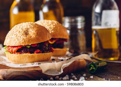 Two Homemade Burger with Some Ingredients and Few Bottle of Beer.