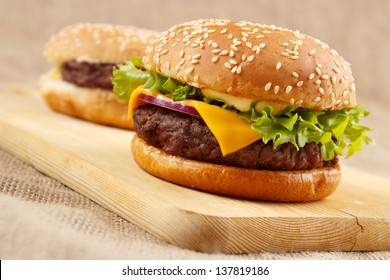 Two homemade grilled hamburgers on wooden board - Powered by Shutterstock