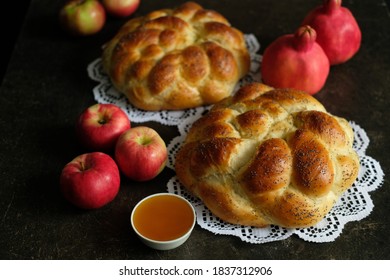 Two homemade round challah with honey,apples and pomegranate for the holiday of Rosh Hashanah