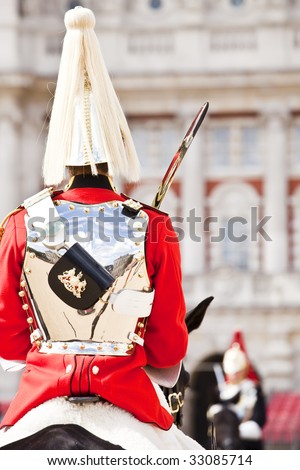 Two horse guards in front each other.