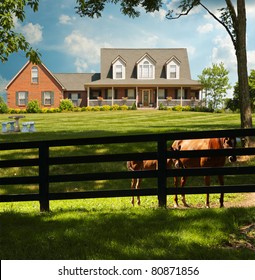 Two horses peek through the fence surrounding a horse farm in Kentucky, USA.