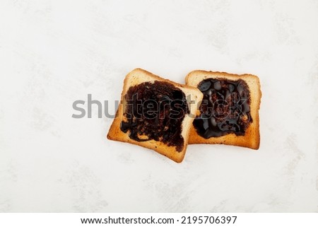 Two Hot toasts for breakfast, top view. Roasted Aussie savory toasts with vegemite spread. Vegemite is a very popular yeast based spread in Australia.
