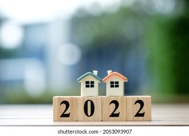 Two House Model On 2022 Wooden Blocks Number. New Year Property Investment Concept.