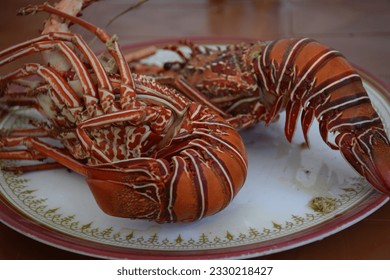Two huge cooked, boiled lobster on a plate close-up - Powered by Shutterstock