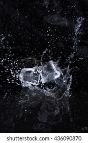 Two Ice Bricks With Water Drops On The Black Background