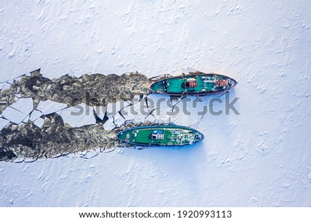 Two icebreakers breaking ice on Vistula river, Poland, 2020-02-18, aerial view